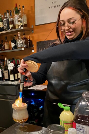 Bartender Taylre Lamendola crafting a tasty cocktail