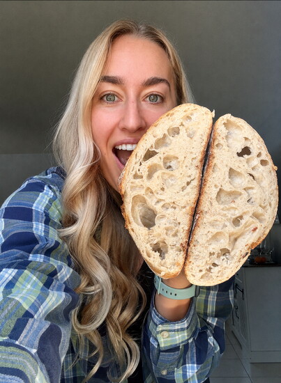 Chloe Seddon, with a loaf of homemade sour dough bread.