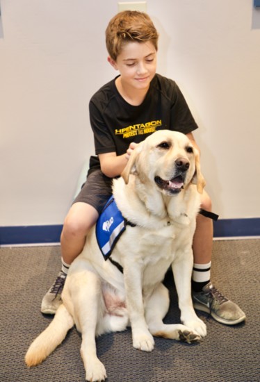 Mitch the Comfort Dog, with a friend at the Lake County Children's Advocacy Center.