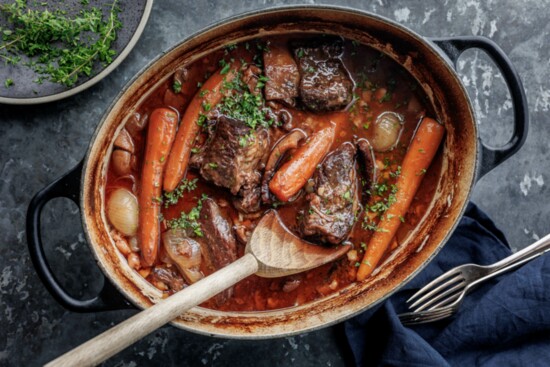 Boeuf bourguignon, traditional beef stew cooked in red wine with onions, carrots and mushrooms.