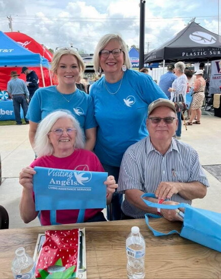 Pam Curl and Tom Strickland (seated) from the Holly Pond Senior Center, with Rachel Thompson and Jennifer Hinds at Senior Day at the Alabama Strawberry Festival