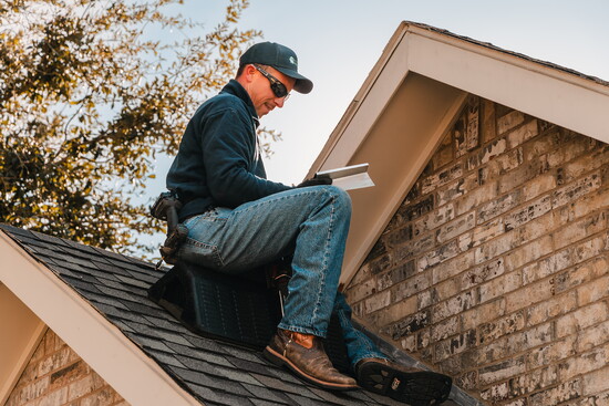 Nathan Archibeque surveying potential gaps for a client's home.