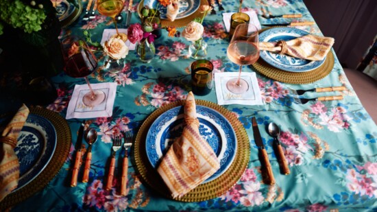 A bespoke table linen produced by Baxter Mill in Rock Hill. Florals by Marigold Floral Design. M&D Threads personalized embroidered napkins.