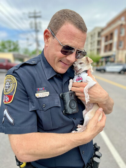 Officer Ryan Schuman with a local pet Lola The Foster Fail   Photo courtesy of @LolaTheFosterFail