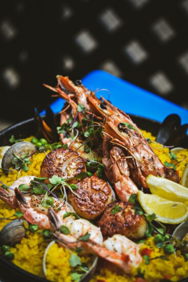 Seafood paella made with Spanish Calasparra rice, saffron, scallops, clams, mussels and head on prawn.