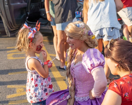 One princess greets another at the Freedom Festival.