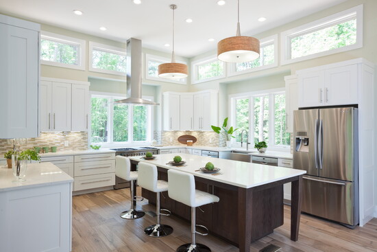 Easy to clean, custom shaker cabinets combined with wood island give this kitchen timeless appeal. 