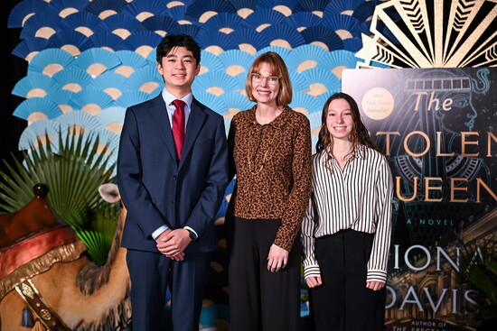 John Cooper Students and authors, Ulysses Hsu ‘26 (left), Jordan Sheirr ’26 (right), stand with Davis.