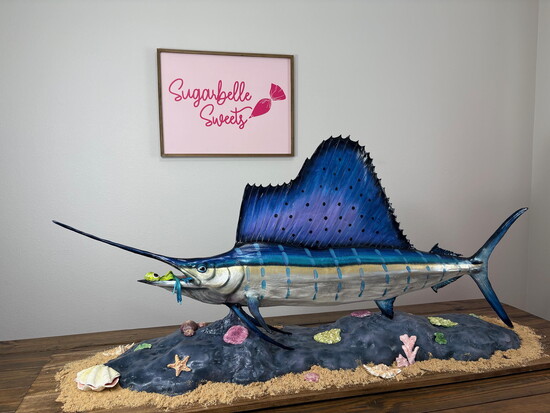 Six-foot sailfish red velvet cake with chocolate squid lure and ocean floor scene.