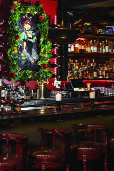 The painting that inspired The Wicked Wolf theme rests on the backbar amongst the spirits.