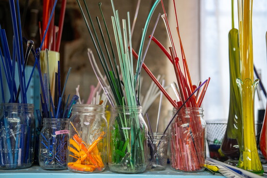 Colored strings of glass at Raging Buffalo Glass. Photo Credit: Sanjay Suchak.