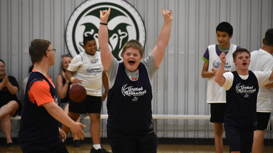 Arc: 2024 Summer Unified Basketball League player Ian Pfeiffer celebrating with his teammates after making a basket