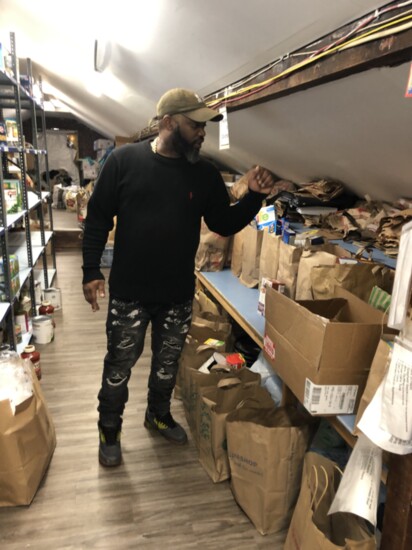 Counting bags of groceries in the food pantry.