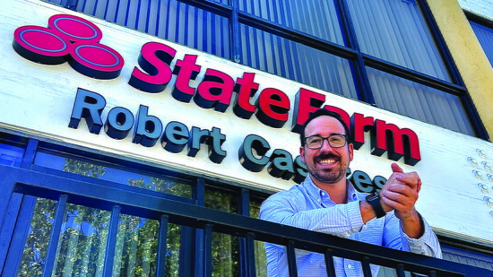 Rob Casares, a State Farm agent in Long Beach, poses on a balcony outside his office, where he serves clients across the community.