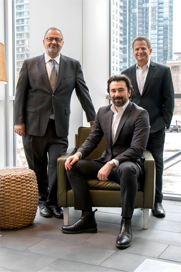 Avli co-owners Louie Alexakis, Ian Vlahakis (seated) and Lou Canellis (Photo credit Mac Yellek)