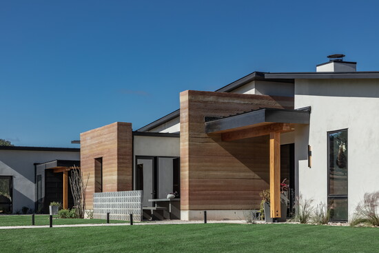 Modernity hugs rammed earth in this design