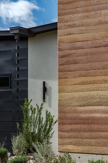 Rammed earth walls are one of the feature elements of the Mustard Architect's design. 