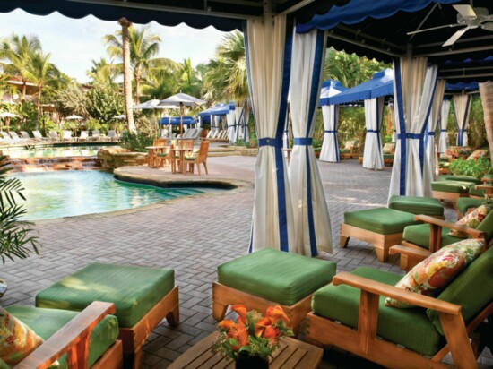 A resort pool on the beach, with delightful cabanas at La Playa in Naples.