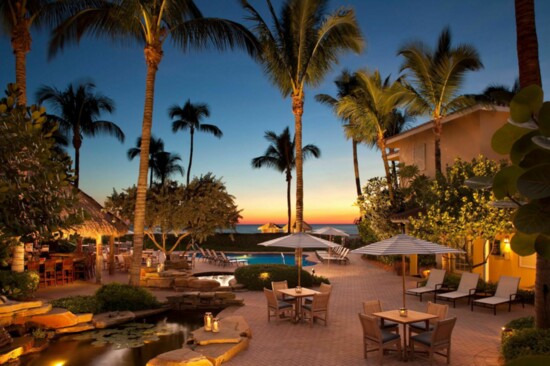 A resort pool on the beach, with exquisite service and delightful cabanas and  at La Playa in Naples.