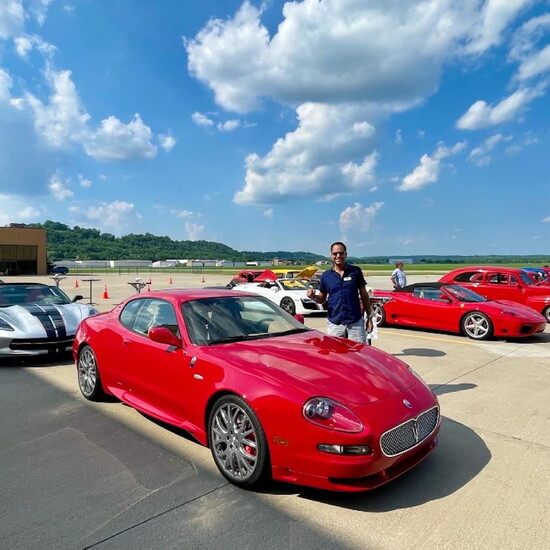 Car enthusiast Benny Rodriguez with his red Maserati. Benny serves on the Cincinnati Concours d’Elegance Board.
