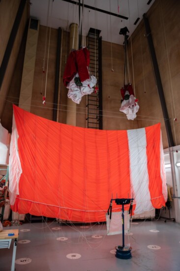 The RAC parachute room has a ceiling high enough to hang parachutes after use to inspect the fabric, lines and cells for needed repairs. 