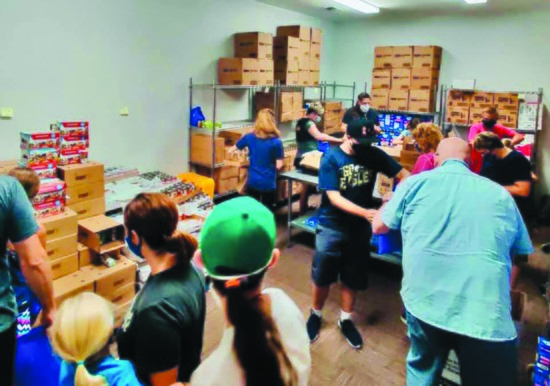 Volunteers organize the Well Food Pantry