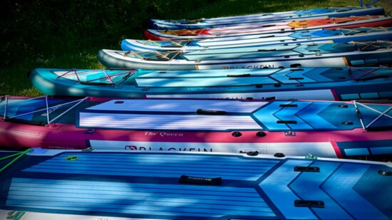 Zen Paddle's colorful paddle boards, equipped with their signature, uplifting sayings