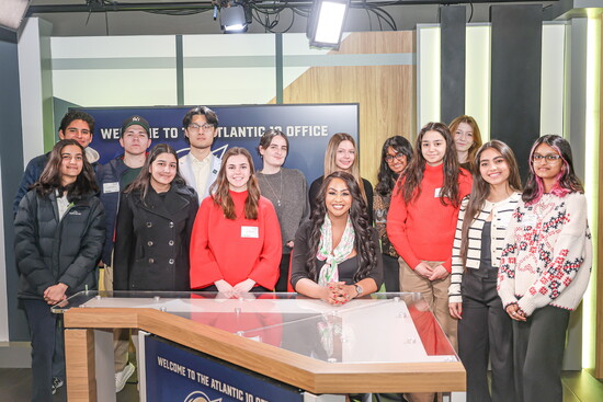 Nelson with students at the Atlantic 10 offices, reflecting her commitment to mentoring the next generation of sports journalists.