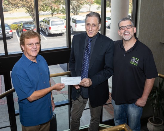 Don Dickerson presents a donation check to Cedarstone Arts Foundation board member Tony Gottlieb and Foundation President Kevin Lawson.