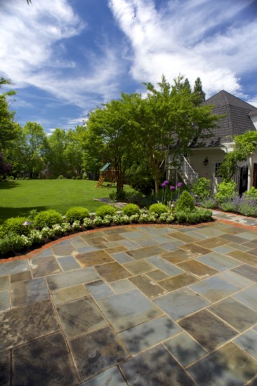 After: Precisely variegated flagstones open to a lush lawn