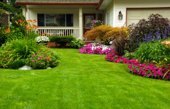 Mounds of color and textures in cottage-style gardening complements traditional architecture. 