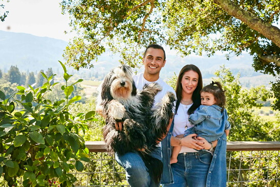Malek holding Bruce Wayne, Torie, and Celine Amrani at their estate. 