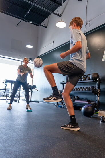 Calhoun treats patient Gus Brisken, sophomore at Moeller High School, for a soccer injury. 