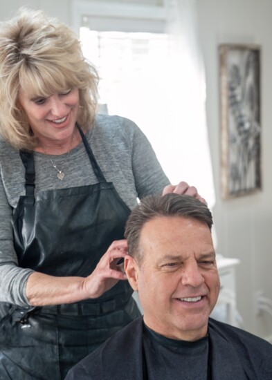 Owner and master stylist Bonnie Upton gives client Mark Lynn the perfect haircut.