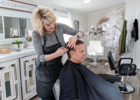 Owner and master stylist Bonnie Upton gives client Mark Lynn the perfect haircut.