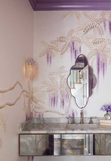An enchanting powder room with de Gournay wallpaper and a custom mirror by Garner Framing.