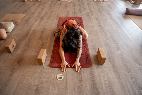 Chyna practicing the Seated Forward Fold exercise