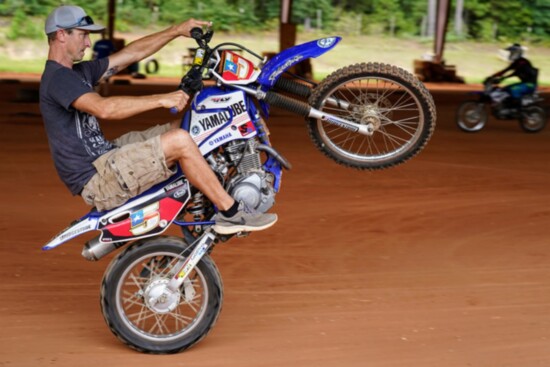 Colin Edwards professionally rode with Yamaha and is demonstrating the wheelie. 