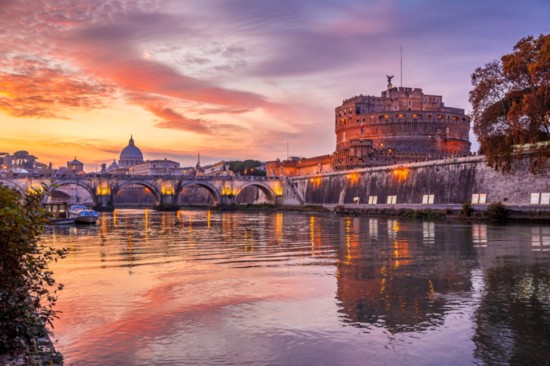 Cityscape from bank of Tiber, with Castel Sant Angelo and Saint Peter in Vatican, Rome, Italy.