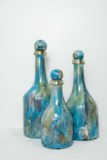 The colors of the sea are marbled into these lovely glass bottles. Hand-blown and hand-painted, made from recycled glass.