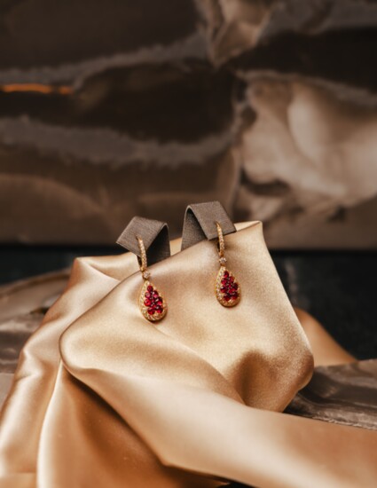 Nothing says "I love you" like 18 karat yellow gold earrings with 1.7 carat ruby clusters accented with 1.05 total carat weight of diamonds.