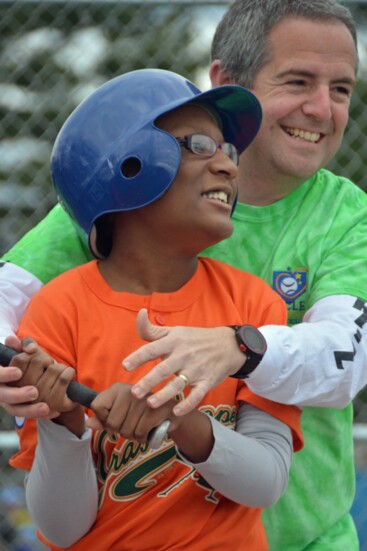 A Miracle League volunteer with one of the group's athletes. 