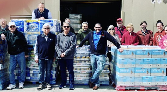 The Rotary’s annual “food caravan” delivers thousands of dollars’ worth of non-perishables for a local food pantry. 