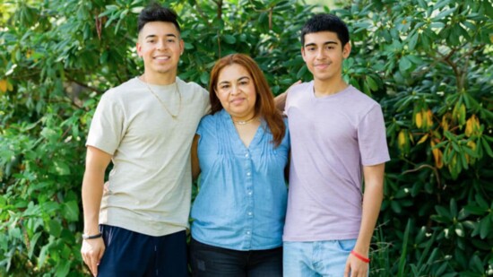 Two brothers, Kevin Ramos, left, and Brian Ramos, flank their mother