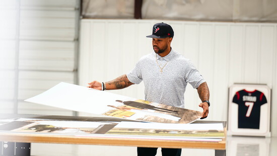 Inside GQ Frames, Quin meets with clients to design custom displays that bring personal stories into focus.