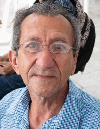 A 76 year old man wearing his new glasses in Medellin.