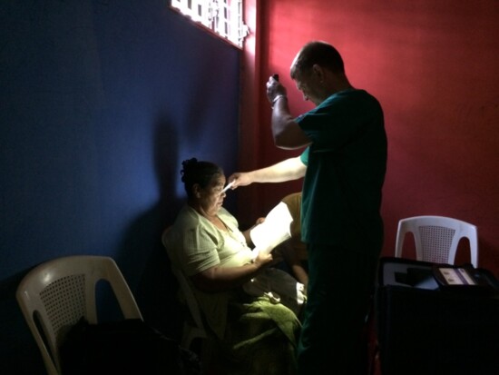 Dr. Michael Thomas working by flashlight after we lost all power in Nicaragua.