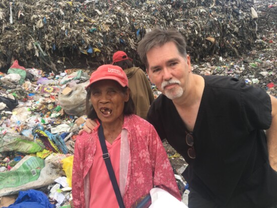 Helping a poor Philippino lady who was scrouging for food in a garbage dump next to our clinic site.
