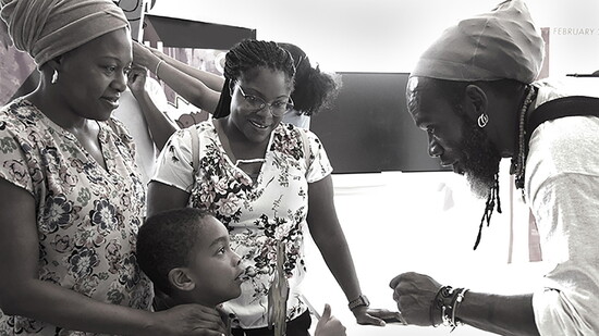 Iyaba Mandigo (a Korry Fellow Artist) with a local family during a community workshop. Photo by Dennis Bradbury.