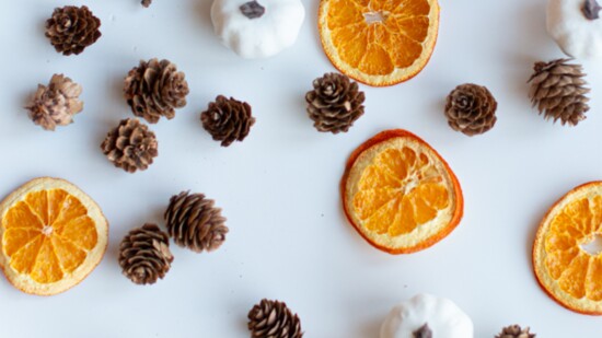 String the organges together with pinecones and glue on pumpkins.